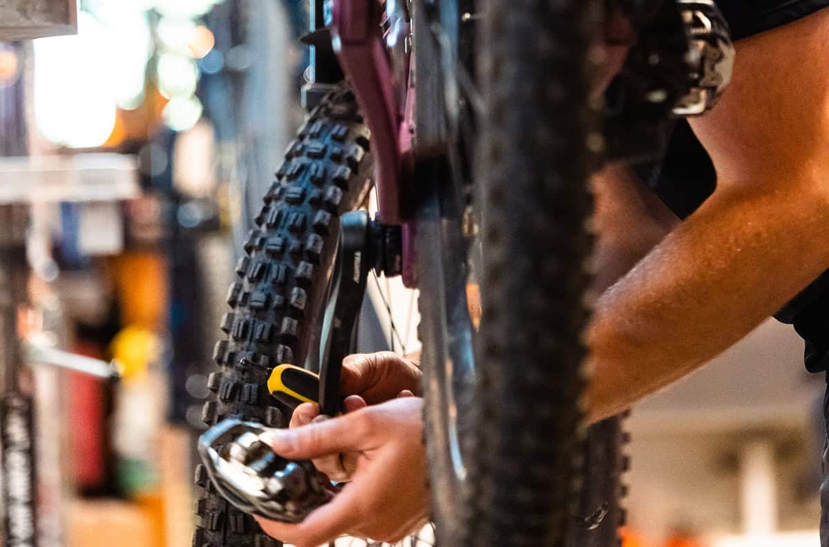 Hub Bike shop mechanic repairing mountain bike at the Hub Pisgah in Brevard